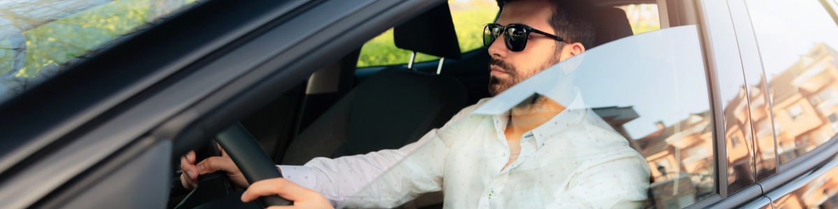 Man driving a car with the window down