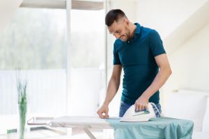 Man ironing shirt