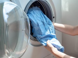 Putting clothes in washing machine