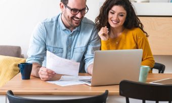 Couple paying bills online at home
