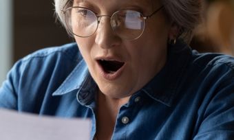Old lady excited looking at energy bill