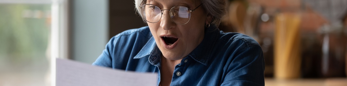 Old lady excited looking at energy bill