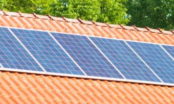 Solar panels on Australian roof with trees in background