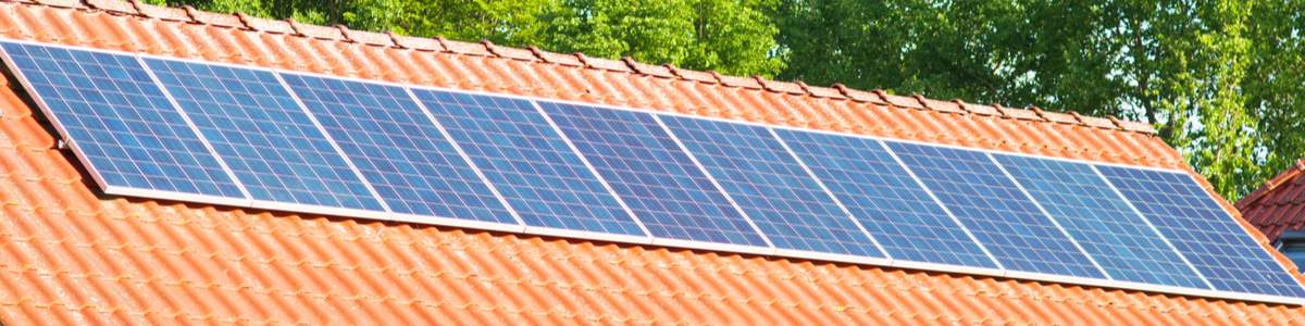 Solar panels on Australian roof with trees in background