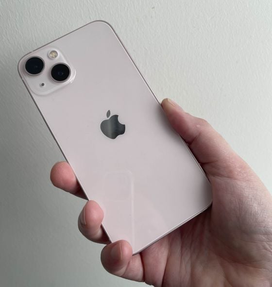 The iPhone 13 held in hand