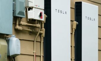 Two Tesla Powerwall 2 units on the side of a house
