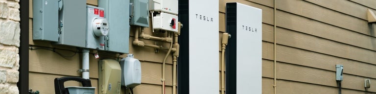 Two Tesla Powerwall 2 units on the side of a house