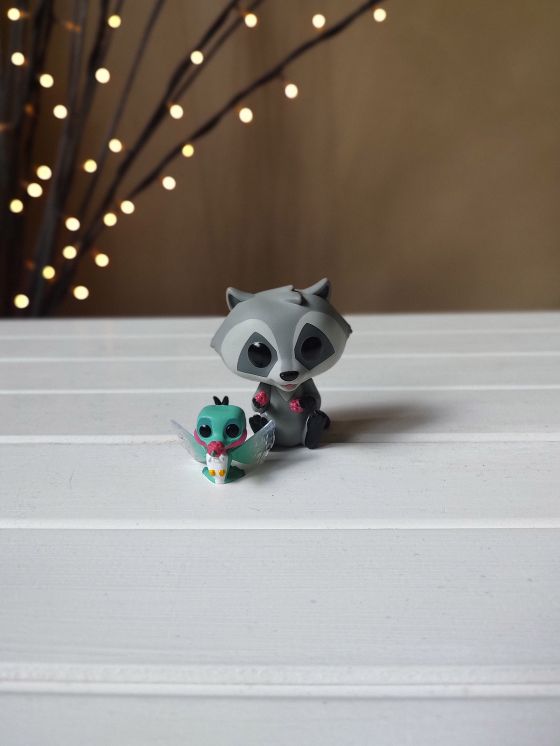 Portrait mode photo of Meeko and Flit Disney character figurines