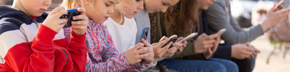 Group of kids looking at smartphones