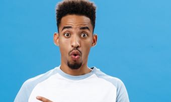 Man with shocked look on blue background