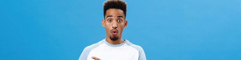 Man with shocked look on blue background
