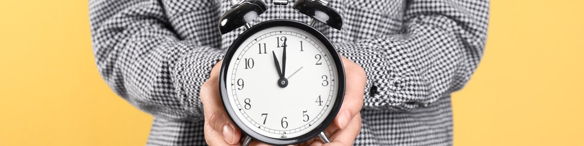 Person holding clock in hands