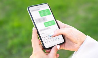 Close shot of woman's hands sending SMS