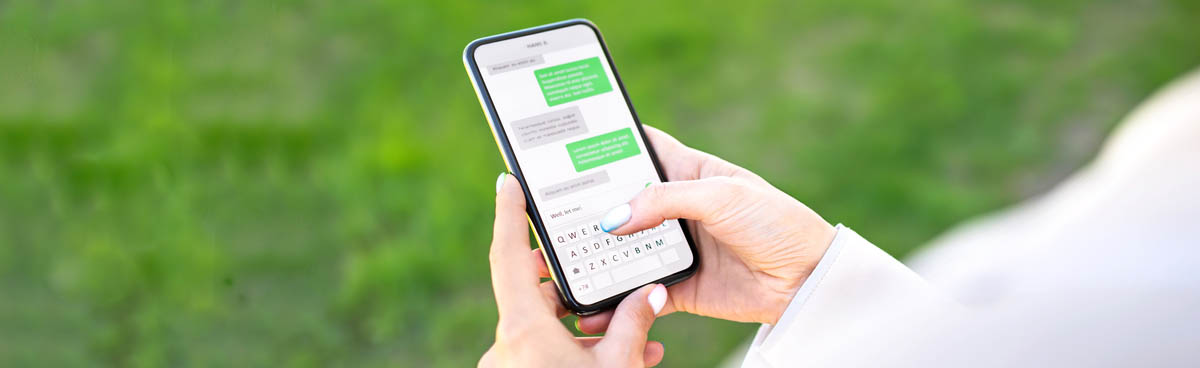 Close shot of woman's hands sending SMS