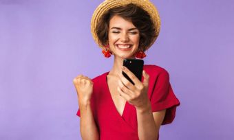 Smiling woman using smartphone