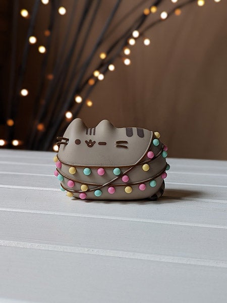 Christmas Pusheen figurine with lights in background