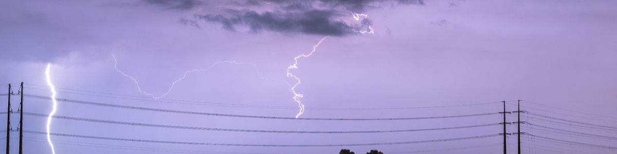 Storm cloud with lighting bolt above a powerline