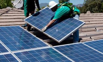 Men installing solar panels on roof