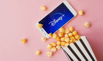 Phone showing Disney Plus logo with bucket of popcorn