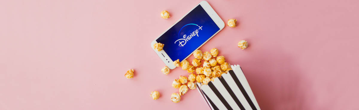 Phone showing Disney Plus logo with bucket of popcorn