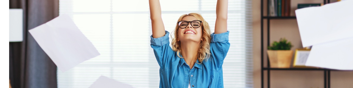 Young lady with hands in the air happy