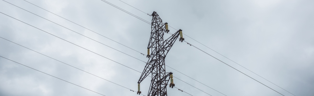 Electricity grid with grey sky background