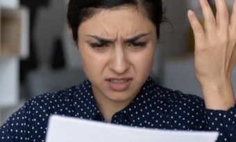 Lady reading bill looking confused