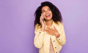 Woman on phone call against purple background