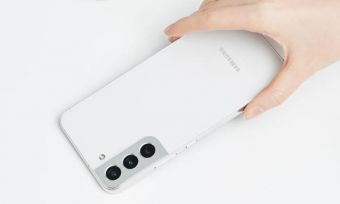 Hand holding white Samsung GalaxyS22 phone