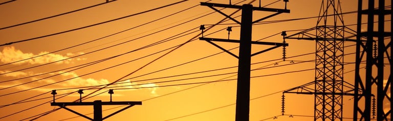 Electricity power lines and grid with sunset background