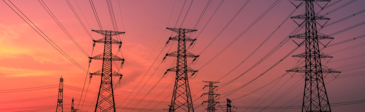 Powerlines with pink and purple sunset in the background