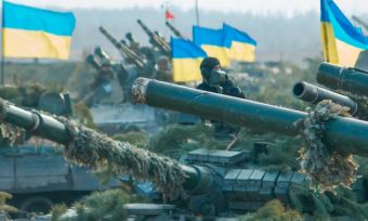 Row of tanks with Ukrainian flags flying