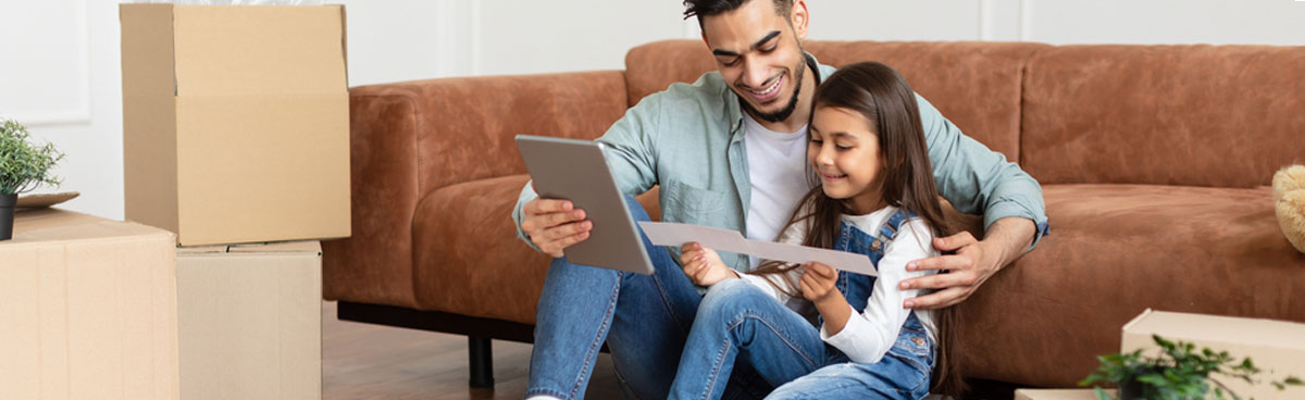 Father and young daughter using tablet together