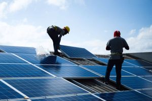 Men installing solar panels on roof