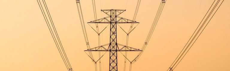 Electricity towers on orange sky background