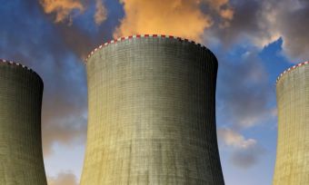 Coal power plants in sunset background emitting gases