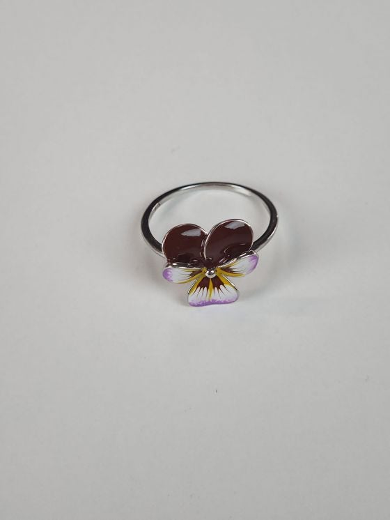 Close-up of a ring with purple pansy detail 
