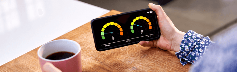Woman's hands using smart energy meter to check time of use tariff