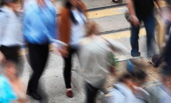 Blurred crowd crossing the road.