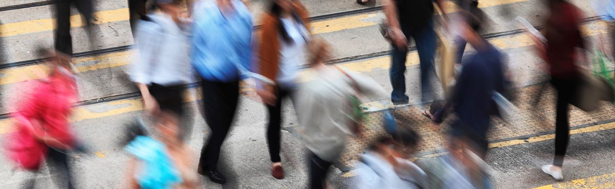 Blurred crowd crossing the road.