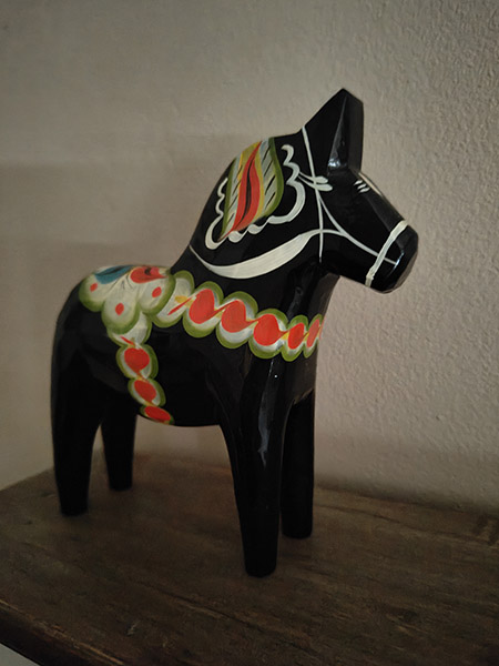 Low light photo of black dala horse ornament