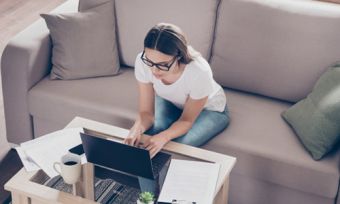 Woman at home looking at laptop