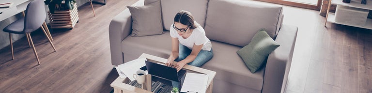 Woman at home looking at laptop