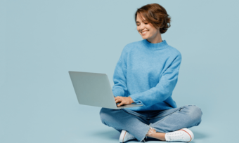 ADSL vs NBN. Woman in blue sweater using laptop