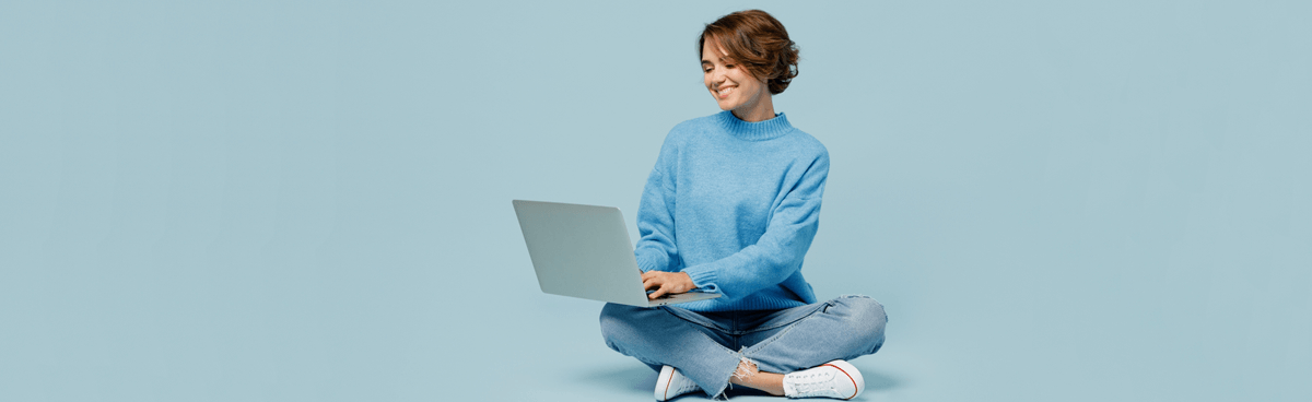 ADSL vs NBN. Woman in blue sweater using laptop