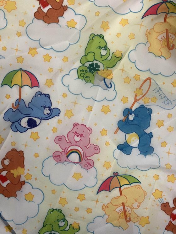 Fabric with print of colourful cartoon Care Bears