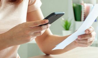 Woman paying bill using smartphone