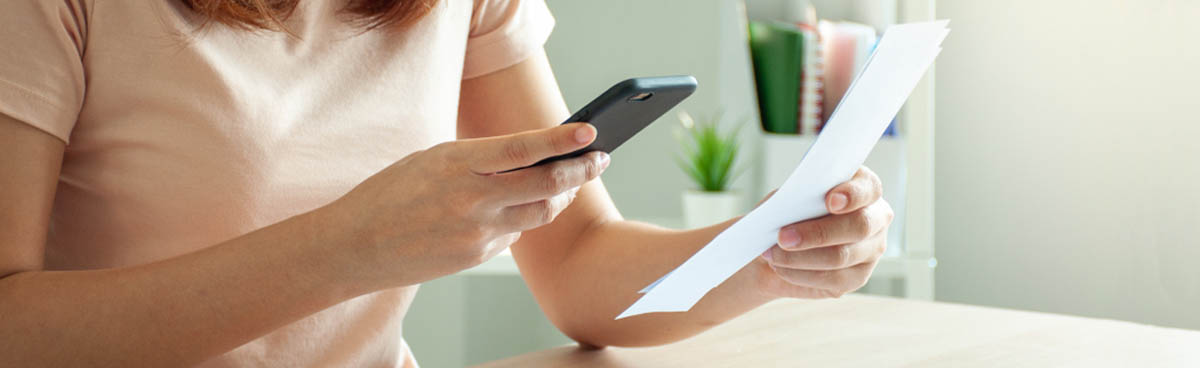 Woman paying bill using smartphone