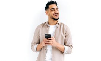 Smiling young man with mobile phone