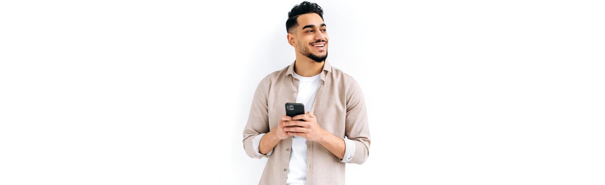 Smiling young man with mobile phone